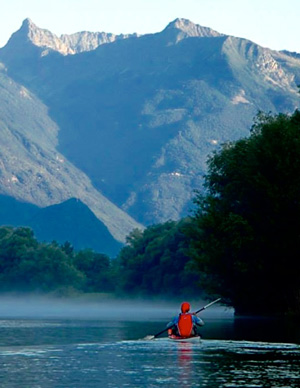 Photo of kayaker with majestic mountain in the background