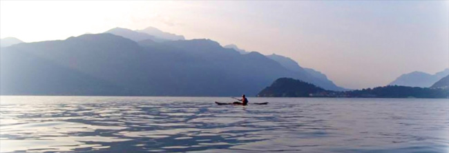 Photo of Kayaker in Lake Como with mount Grigna and Bellagio in the background