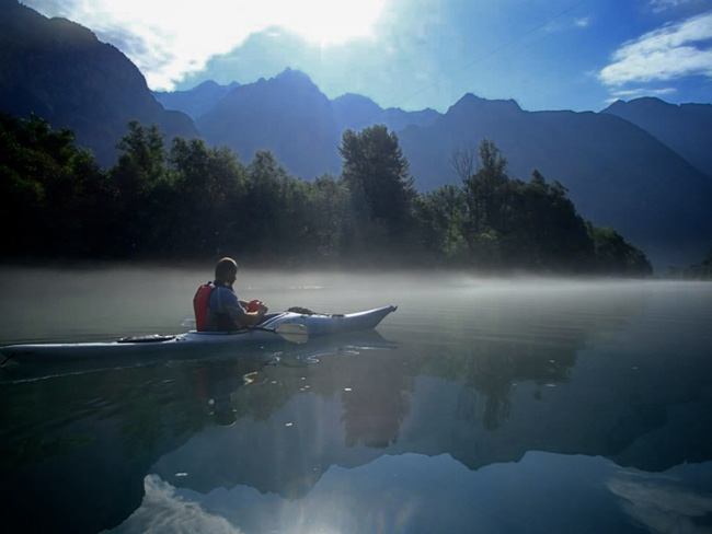 Photo of Kayaker on Lake Como with mist on the lake