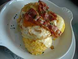 Polenta topped with eggs and bacon.